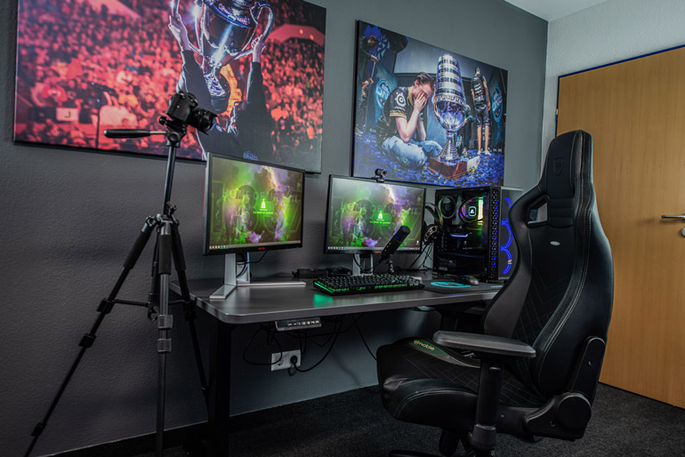 gaming room with monitors and chair
