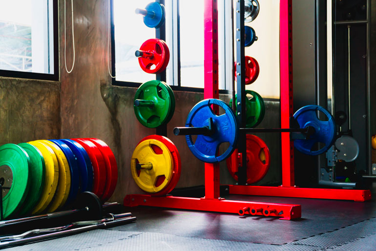 squat stand loaded with colorful weight plates