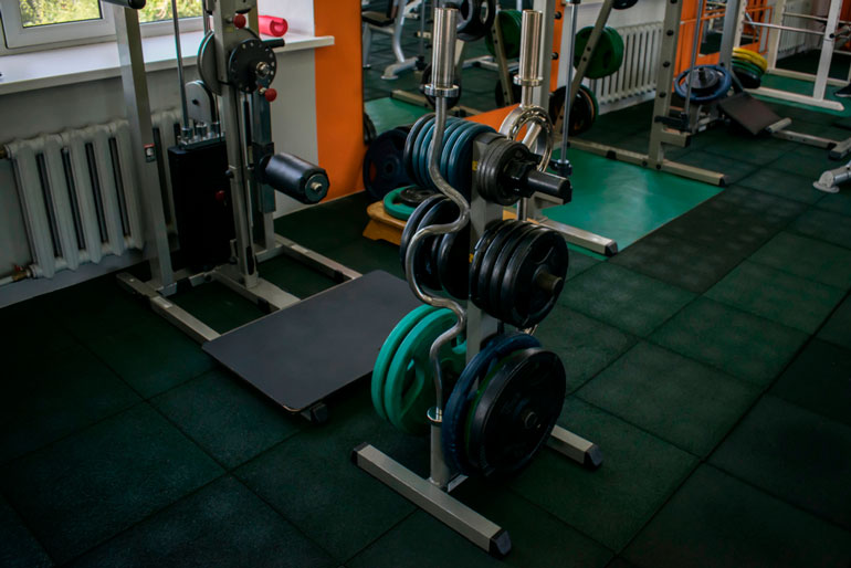 vertical weight rack with barbells and plates