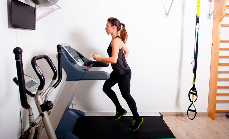 woman is exercising on treadmill at home