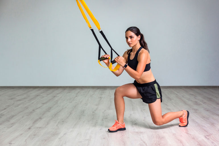 woman is working out TRX with band